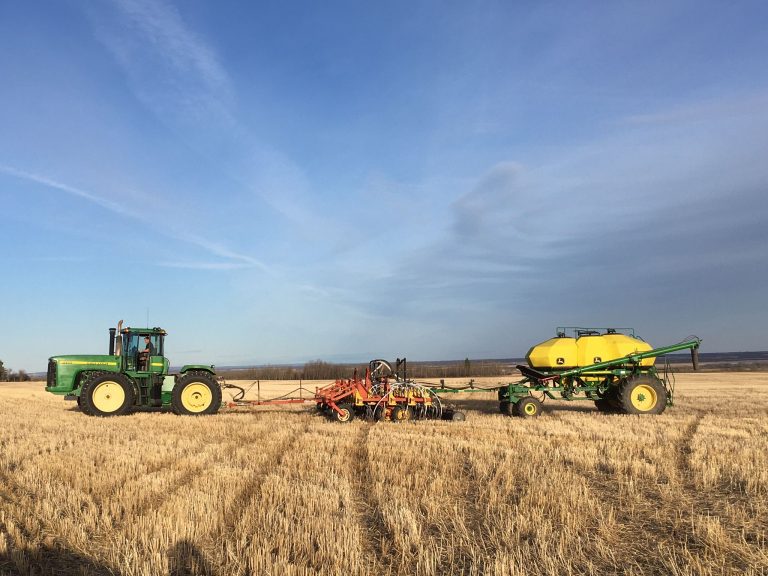 Farm tractor and seeding equipment at a Grande Prairie farm